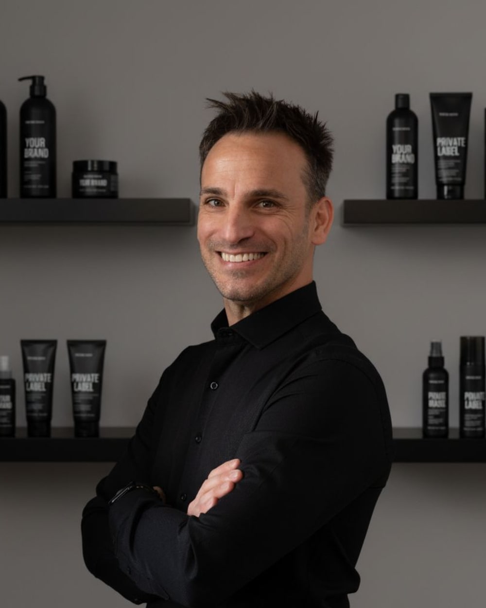 Claudio Nicodemo in front of shelves of private label cosmetics